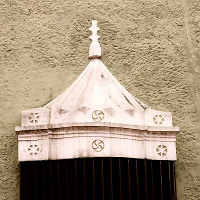 Basque lauburu on a colonial home window decoration in Valladolid. <a href=></a>